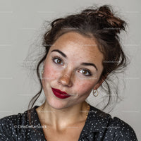Portrait of a Smiling Woman with Freckles and Bright Red Lipstick