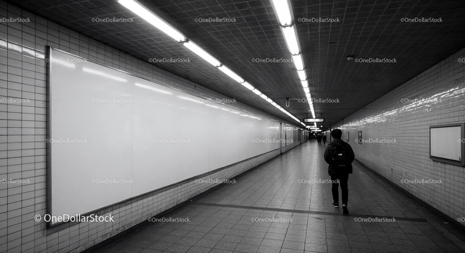 Underground subway tunnel with fluorescent lighting and tiled walls