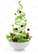 Fresh green salad with cucumber spiral and black olives