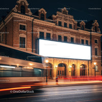 Night view of historic building with blank billboard
