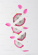 Floating dragon fruit slices with pink petals on white