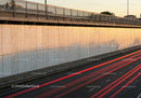 Urban Highway Wall with Light Trails and Safety Railings at Dusk