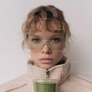 Young Boy Wearing Safety Goggles Holding Green Smoothie
