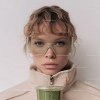 Young Boy Wearing Safety Goggles Holding Green Smoothie