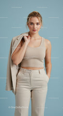 Elegant Woman in Beige Tank Top and Trousers with Blazer Over Shoulder