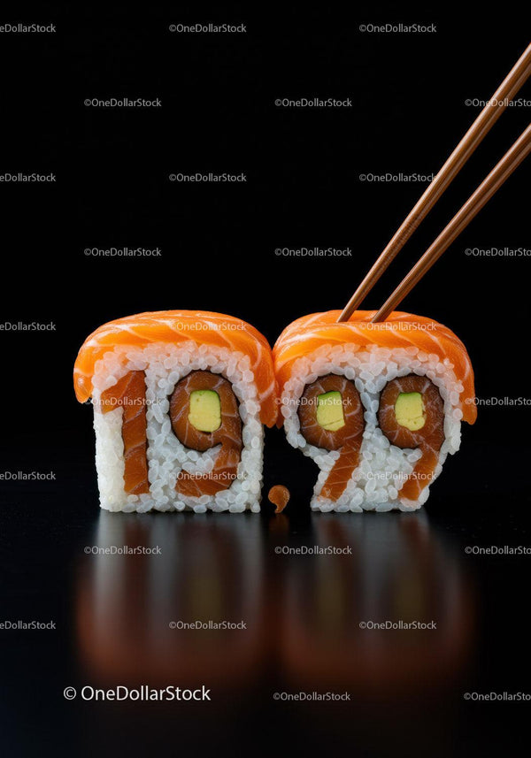 Close-up of salmon sushi rolls with chopsticks