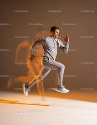 Athlete sprinting fast in gray sportswear with motion blur