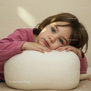 Thoughtful Child Resting Head on White Cushion