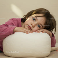 Thoughtful Child Resting Head on White Cushion