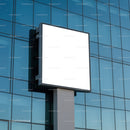 Blank square billboard on modern glass office building