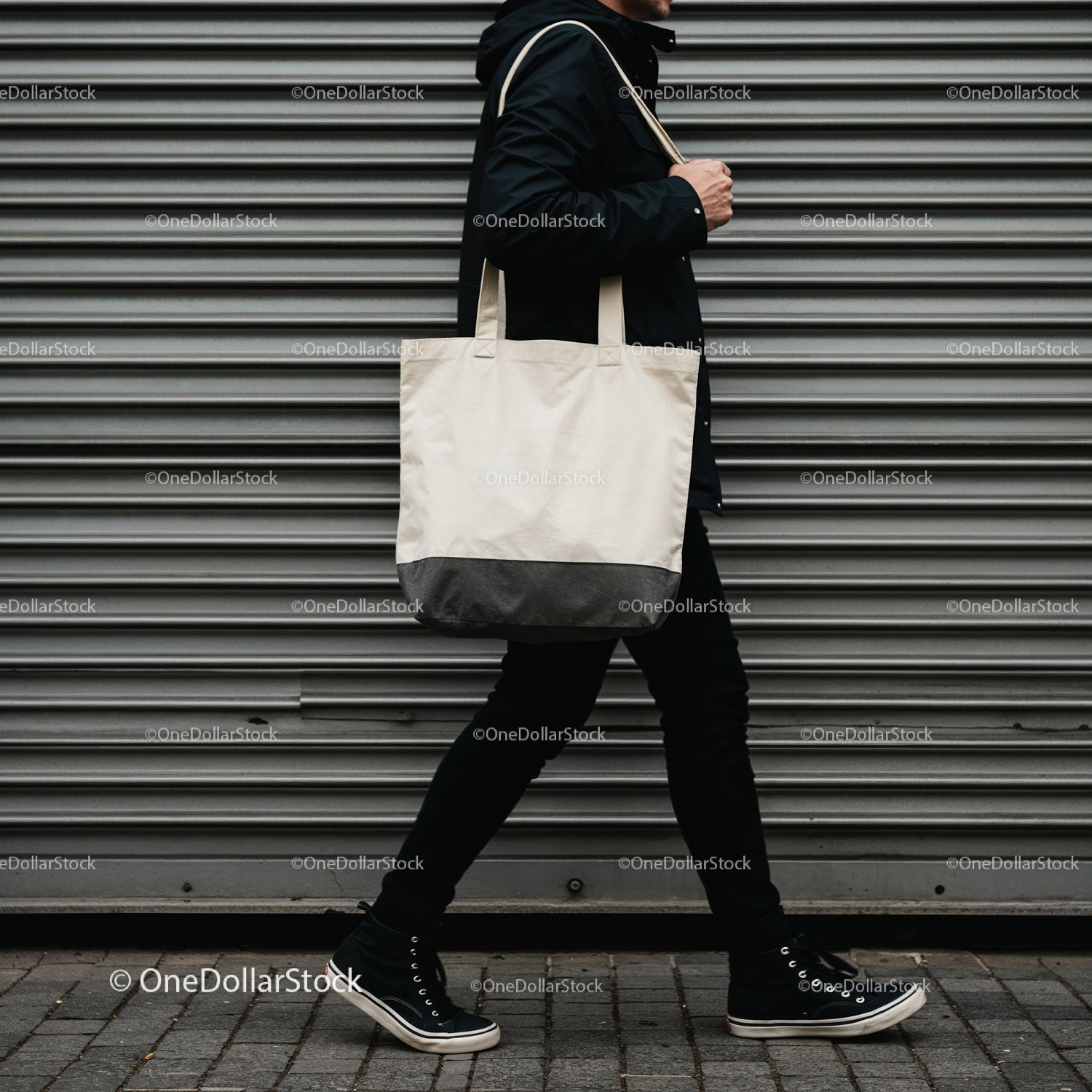 Person walking with white canvas tote bag on city street