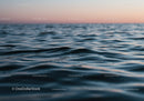Serene Ocean Surface with Gentle Waves During Sunset Twilight