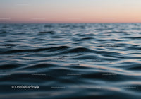 Serene Ocean Surface with Gentle Waves During Sunset Twilight