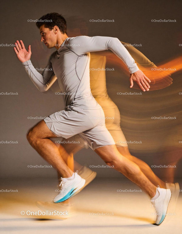 Focused young athlete sprinting with dynamic motion blur