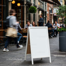 Blank Sidewalk Sign Outside Bustling Urban Cafe