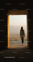 Woman walking barefoot through open doorway to nature