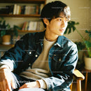 Young man enjoying warm sunlight in cozy room