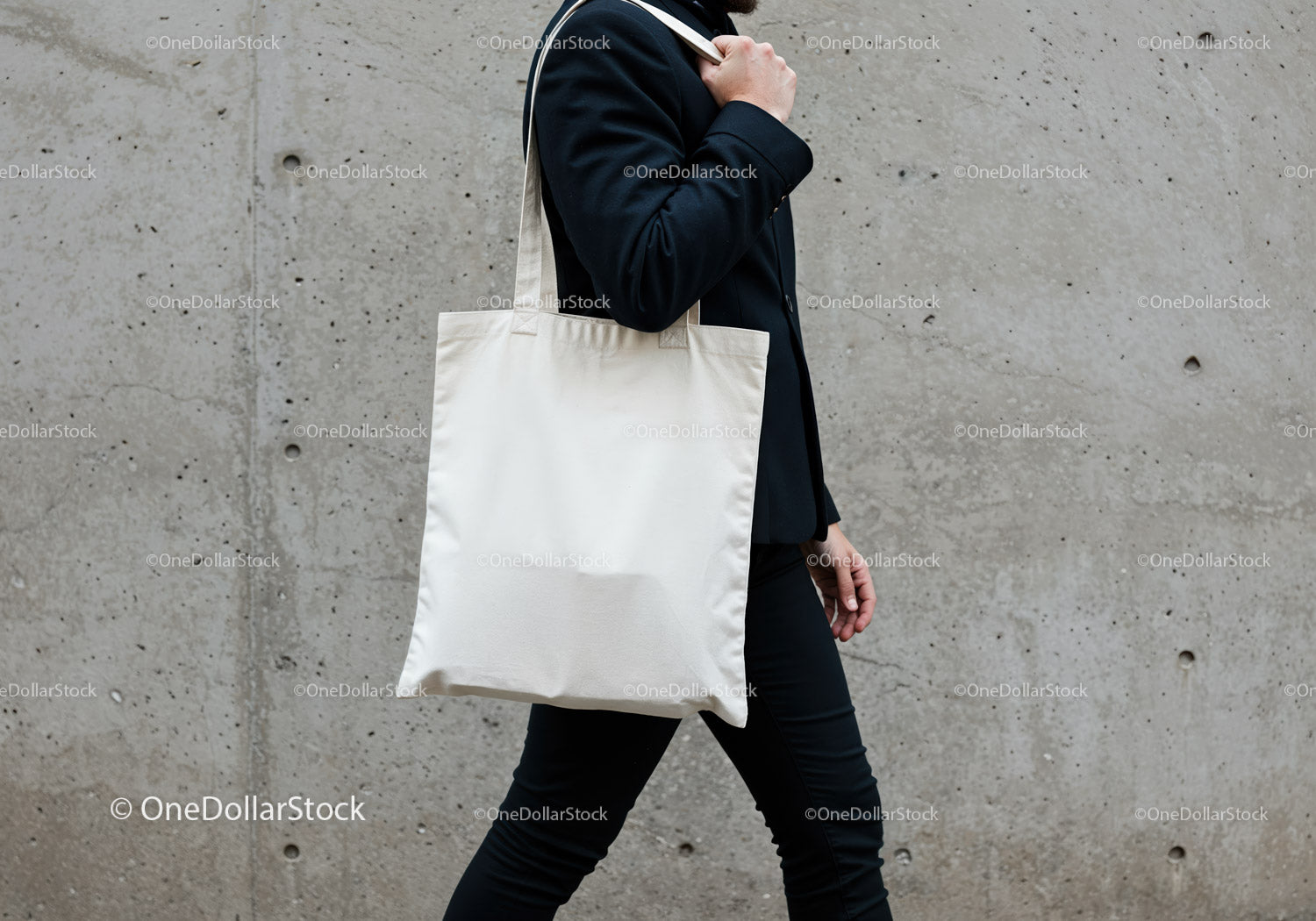 Man carrying blank white tote bag walking outdoors