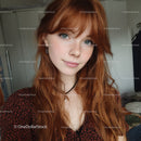 Young Woman with Red Curly Hair and Blue Eyes in Casual Indoor Setting