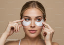 Young Woman Applying Eye Patches for Skincare Treatment