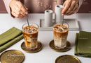 Refreshing Iced Coffee with Milk and Ice Cubes on Elegant Golden Plates