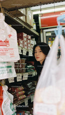 Young woman shopping in cozy Asian market aisle