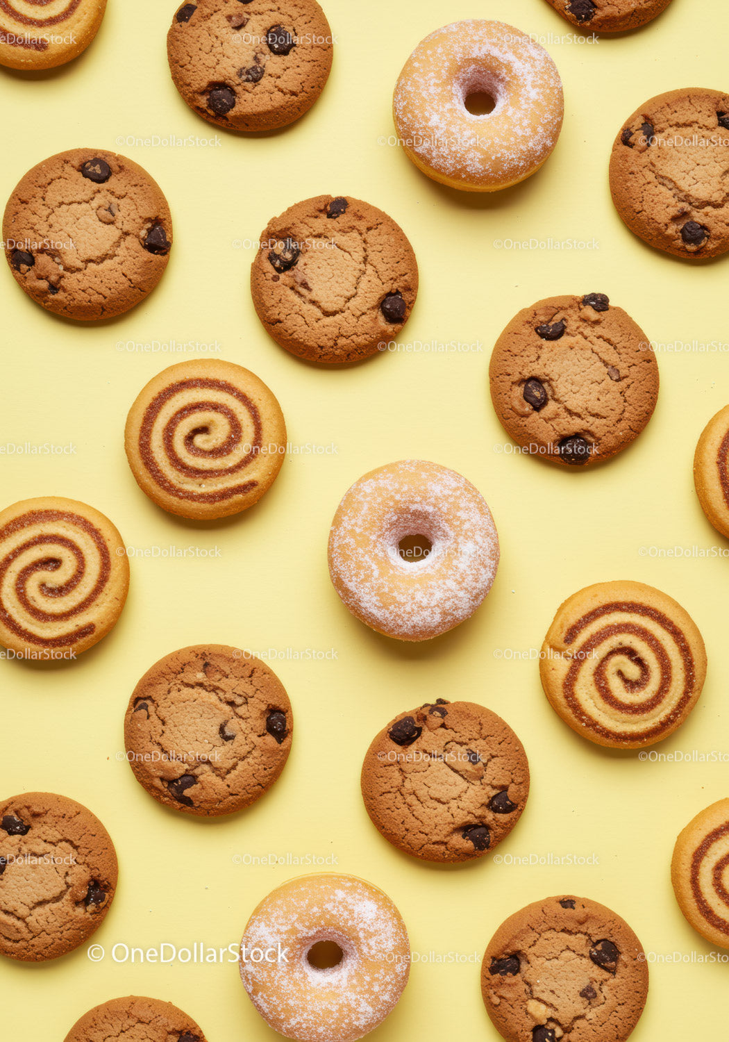 Assorted chocolate chip cookies and sugar donuts on yellow