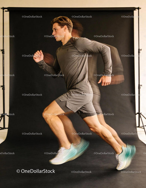 Young man sprinting indoors in athletic wear
