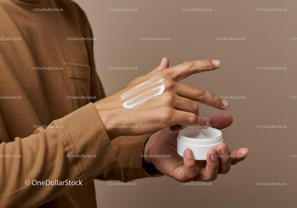 Man Applying Hand Moisturizer in Personal Care Routine