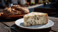 Herb-Infused Cheese Wedge with Rustic Baked Bread on Wooden Table