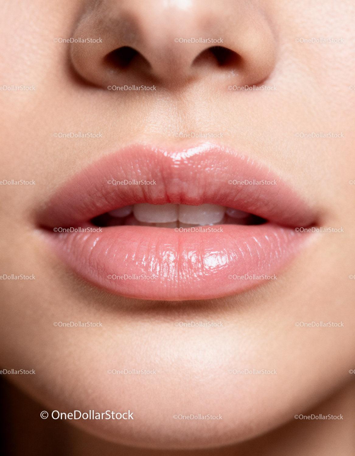Close up of natural soft lips with subtle gloss