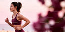 Focused woman running outdoors in soft evening light