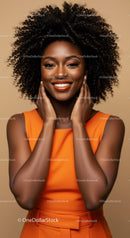 Joyful Woman in Stylish Orange Dress with Curly Hair