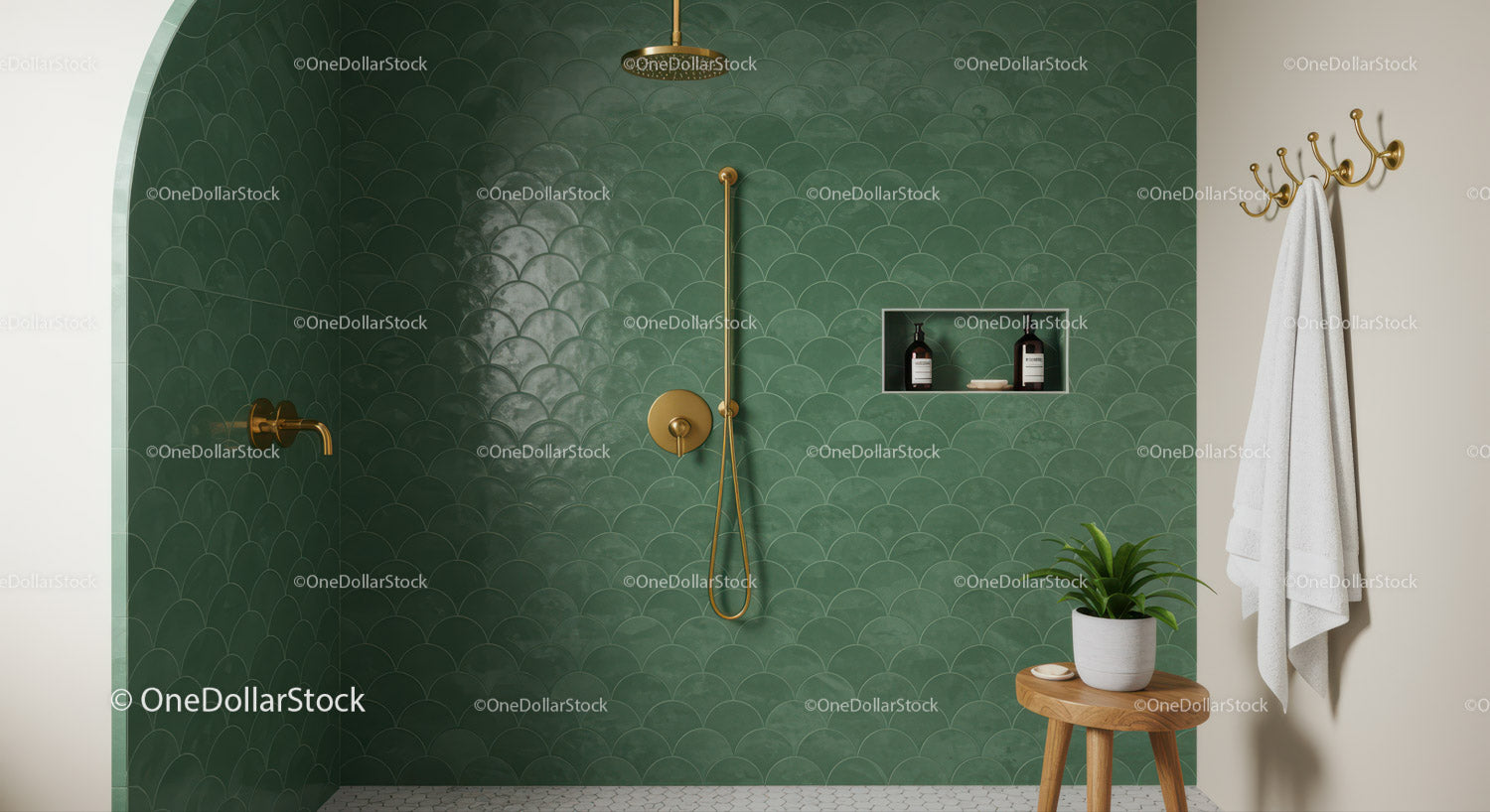 Minimalist green tiled shower with gold fixtures and plant