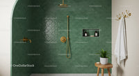 Minimalist green tiled shower with gold fixtures and plant