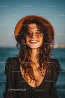 Smiling Woman Wearing Sunglasses and Hat at the Beach