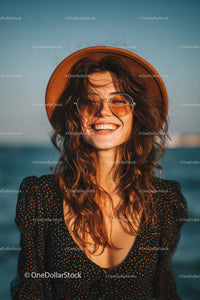 Smiling Woman Wearing Sunglasses and Hat at the Beach