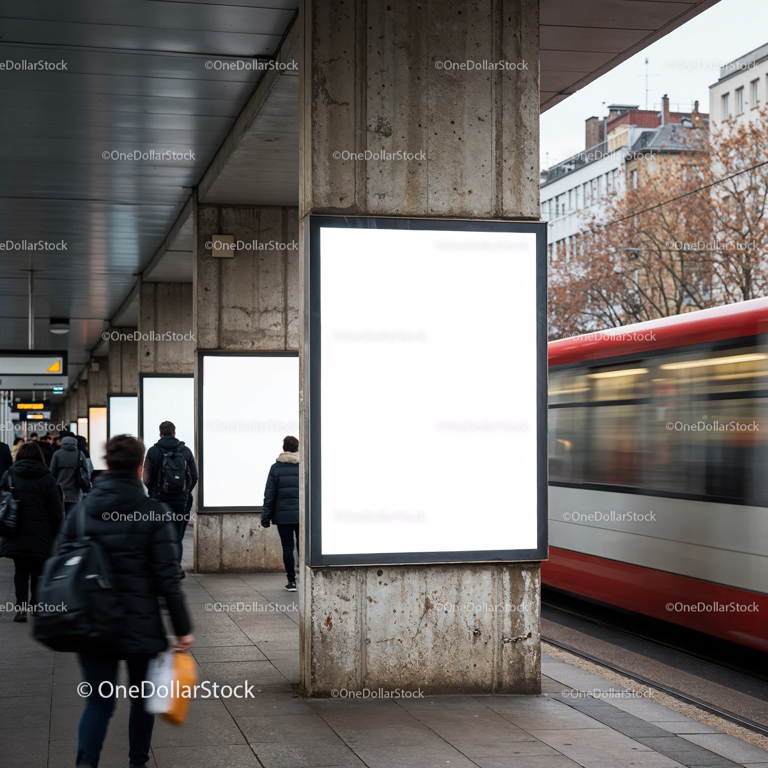 Commuters walking past blank urban advertisement panels