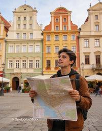 Young man exploring city streets with detailed map