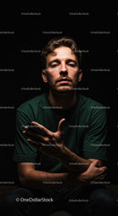 Thoughtful young man in dark dramatic lighting