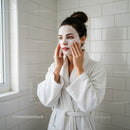 Woman Applying Facial Mask in Bathroom for Skincare Routine