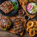 Assorted Grilled Meats and Seafood with Fresh Salad on Wooden Boards