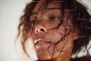 Close-up of Smiling Woman with Wet Hair and Freckles