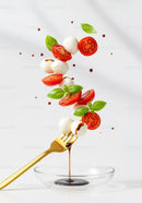 Fresh Caprese Ingredients Floating Above Fork with Balsamic