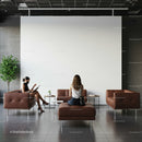 Two women sitting in modern lounge with brown sofas