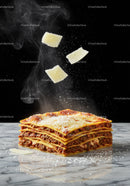 Steaming layered lasagna with falling Parmesan cheese