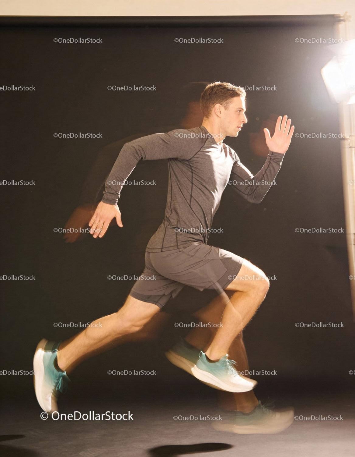 Athletic man sprinting fast indoors with motion blur