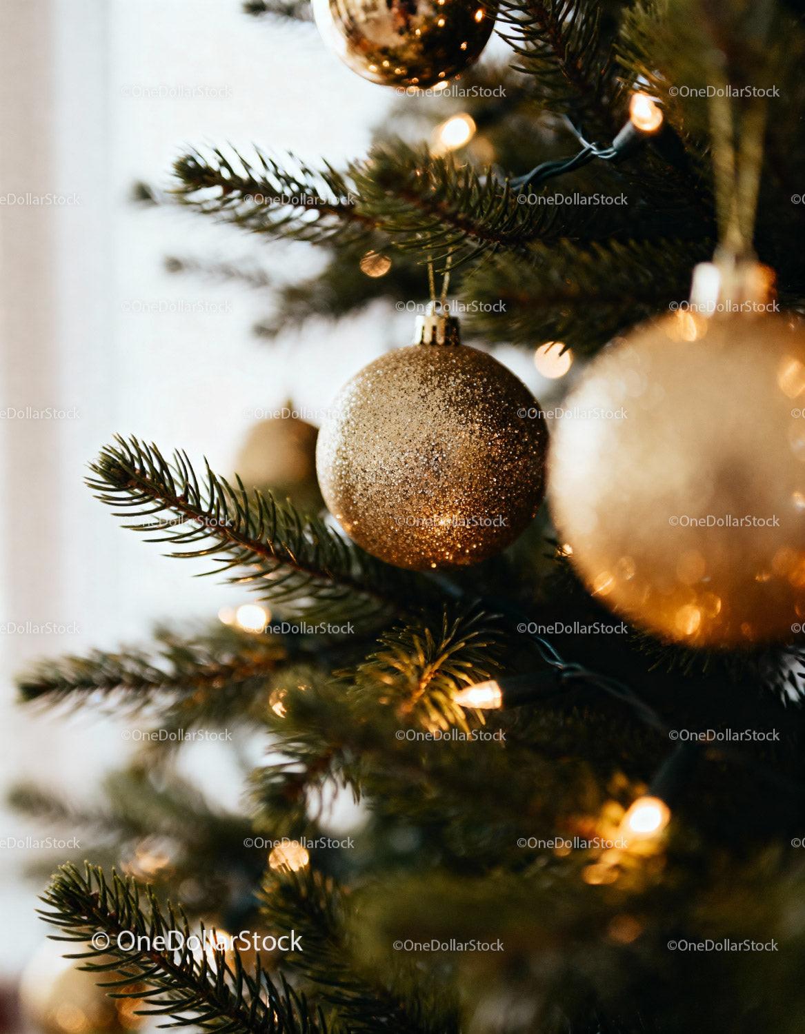 Close up of golden bauble on decorated Christmas tree