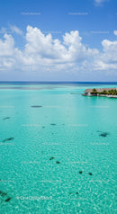 Tropical Overwater Bungalow Surrounded by Clear Turquoise Ocean and Blue Sky