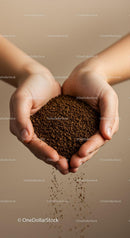 Hands gently holding and pouring instant coffee granules